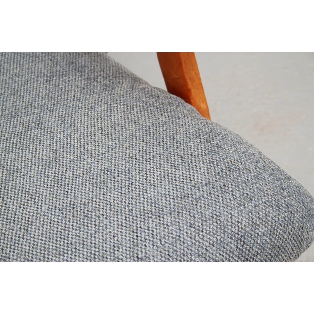 Beautiful 1950s armchair. Solid cherry wood legs. The seat has been reupholstered and freshly covered. The color of the...