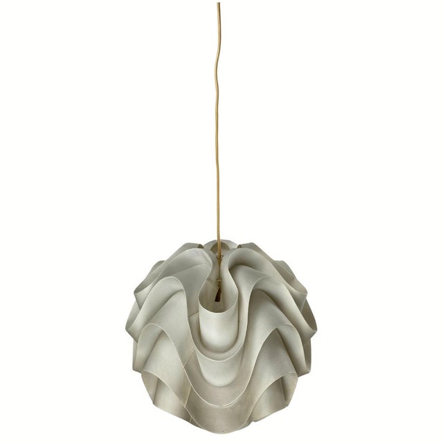 An extremely early first edition original model 172 Le Klint freeform hanging lamp by Poul Christiansen, 1971. These lamps...