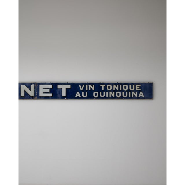 This 20th Century French Dubonnet tonic wine metal sign is a classic example of early advertising design, showcasing the...