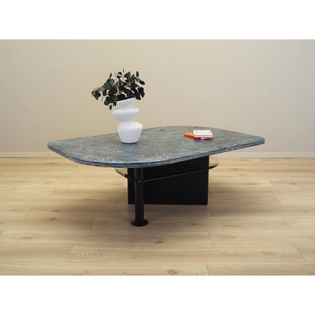 The coffee table was made in the 1980s, Italian production. Table top made of marble, structure made of wood. Surface...