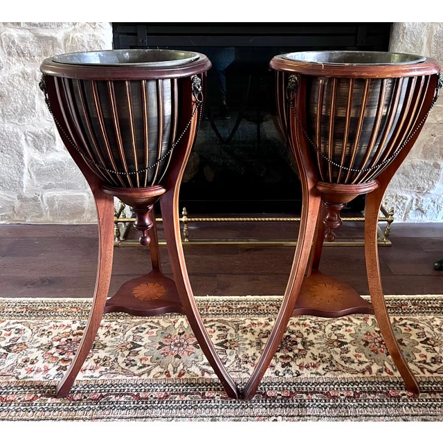 Matched pair of Edwardian-style slatted mahogany jardinieres (plant stands / wine coolers). Brimming with classic English...