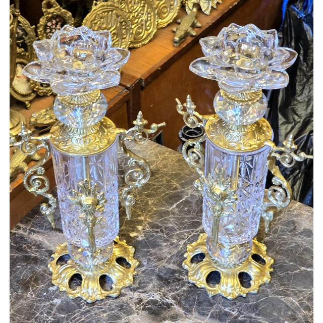 This brass and crystal candlestick holder is a refined decorative accent crafted to elevate luxury interiors. Its solid...