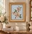 Charming vintage floral needlepoint featuring a delicate arrangement of soft blush, cream, peach, and green flowers worked...