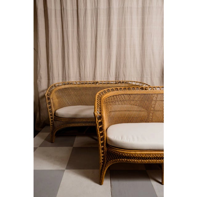 The Amira Moroccan Loveseat features elegant natural wood tones and a distinctive circle weaving detail along the edges....