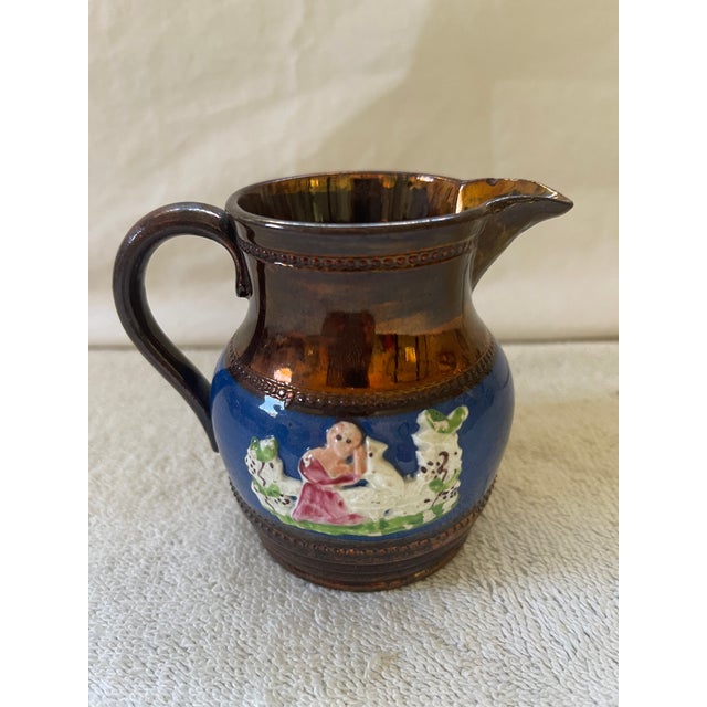Antique and rare English Lusterware small jug for cream. The dark copper finish is a touch darker. Lots of details on the...