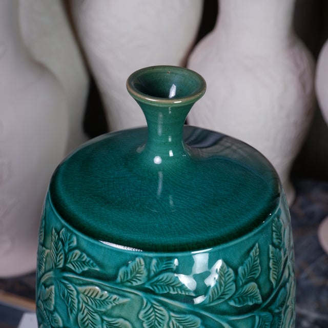 This exquisite ceramic vase handcrafted by Pottery 12, a celebrated Hanoi based studio celebrated for its sculptural...