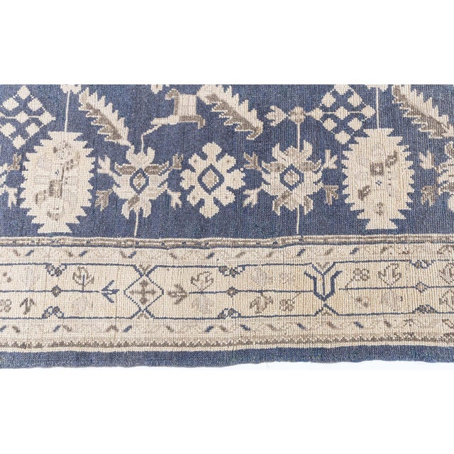 Striking in both composition and palette, this antique Turkish Oushak rug from the 1920s is a bold example of Anatolian...