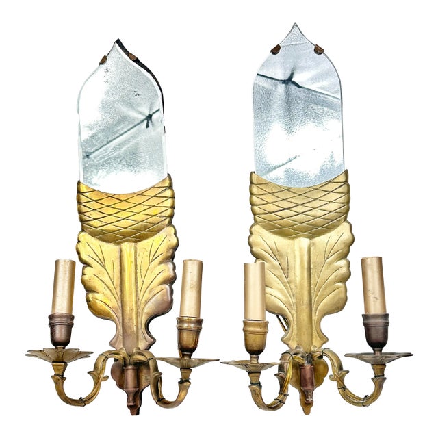 Stunning pair of vintage brass and mirrored sconces by Chapman. Features a double light. Solid brass with wood backing....