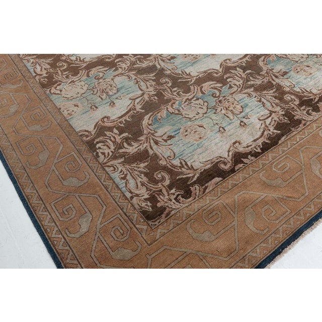 A rare example of early 20th century hand-knotted wool Indian rug. The main field displays a bold design consisting of a...