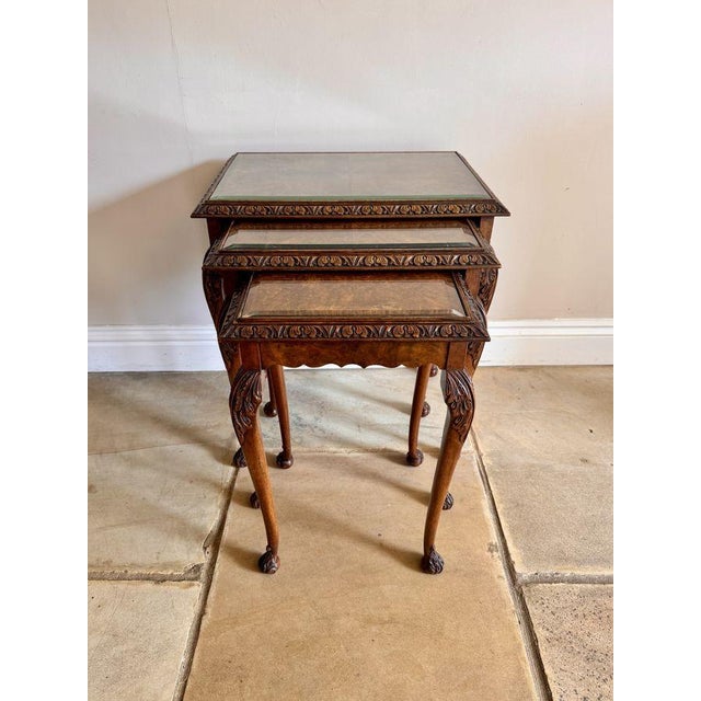 Outstanding quality antique walnut nest of three tables, having outstanding quality walnut rectangular shaped tops with a...