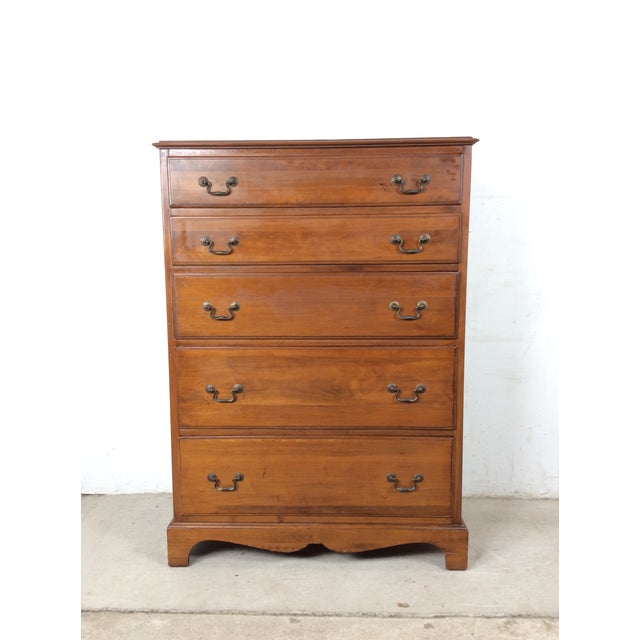 This mid century colonial revival highboy dresser features hardwood construction, original maple finish, five dovetailed...