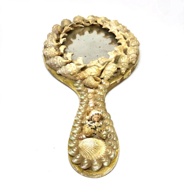 A fine and unusual Victorian period hand mirror with an applied shell decoration. The mirror retains its original plate...