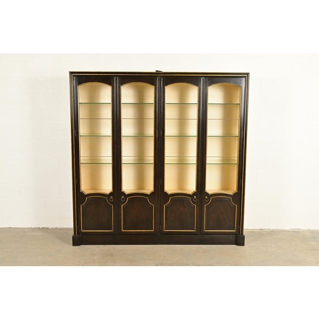 A gorgeous French Regency Louis XVI style lighted breakfront bookcase or dining cabinet By Baker Furniture USA, Circa...