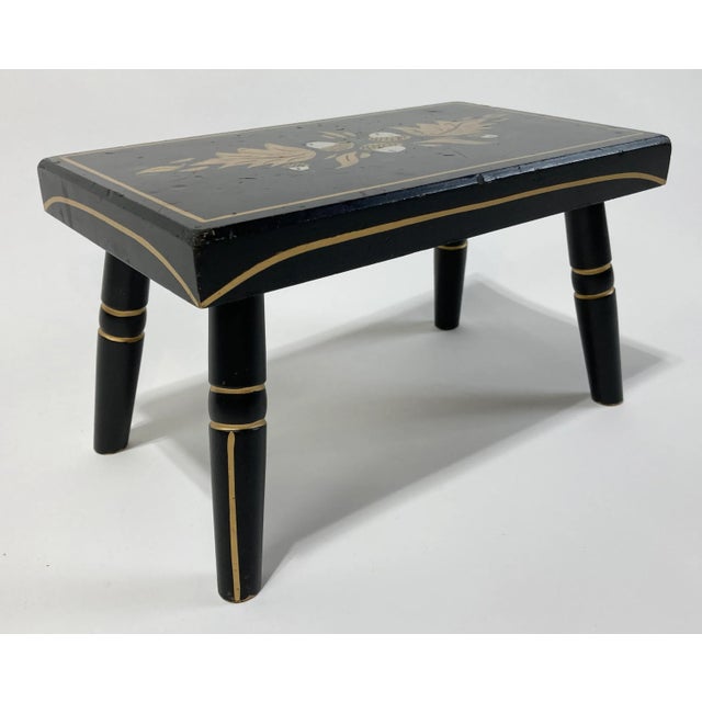 Petite folk art foot stool featuring a black base and hand-painted acorns and gold colored leaves. Metallic gold painted...