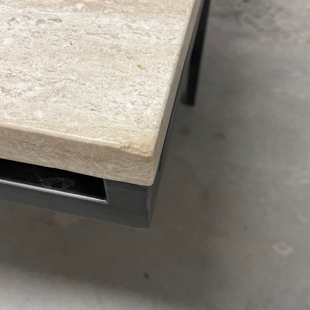 Sleek brushed steel base and travertine veneer top. This coffee table is delightfully different with a industrial feel but...