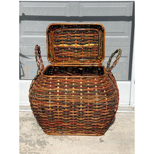 Large decorative lidded storage basket made of woven colored rope. Bamboo reed strapping with interwoven rope and wood...