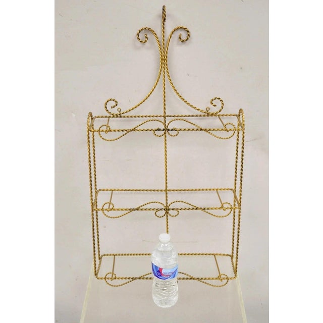 Vintage Gold Gilt Metal Hollywood Regency Scrolling Iron 3 Tier Small Wall Shelf (no glass). Circa Mid 20th Century....