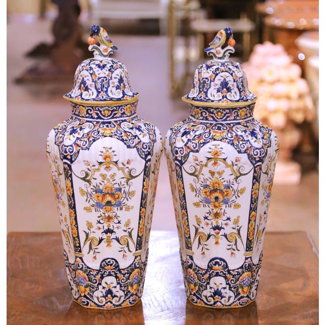 This elegant pair of antique French faience covered vases was crafted in Desvres, France circa 1870. Each vase features a...