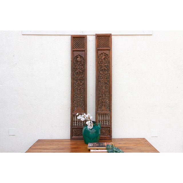 An exquisite study in vertical wood artistry, this is a pair of 19th-century architectural panels hand-carved from solid...