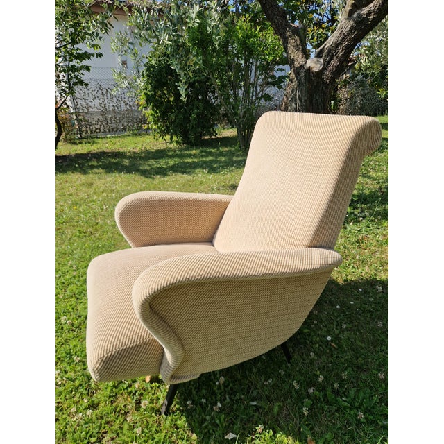 An elegant pair of Italian modernist lounge chairs, designed by Marco Zanuso. The seats feature an organic, enveloping...