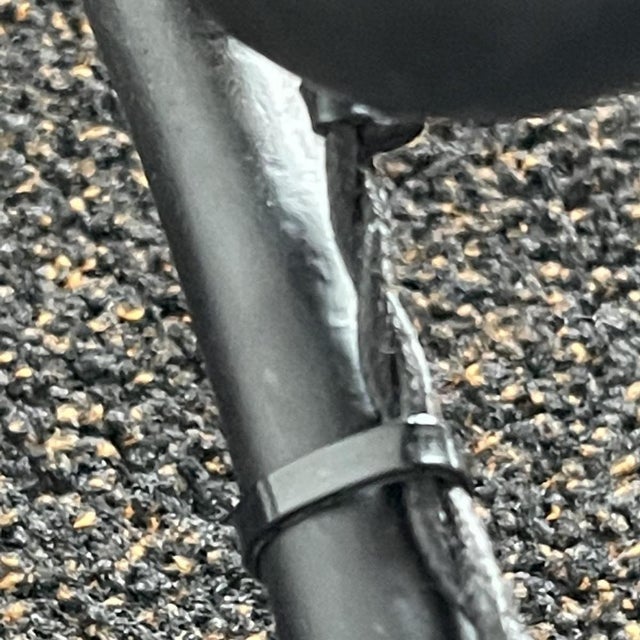 Round-section tubular steel floor lamp with openwork circular base, circa 1970. Attributed to mathieu matégot, the teak...