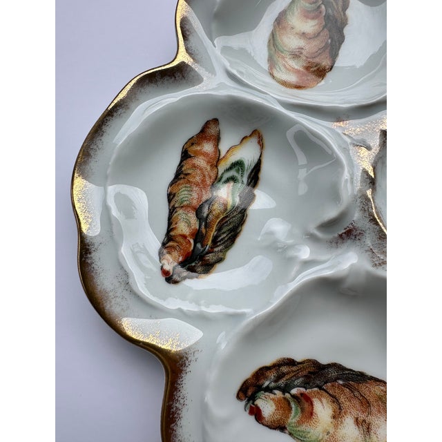 This exceptional and rare antique Limoges oyster plate, crafted by Lafarge & Cie, is a true treasure for any discerning...