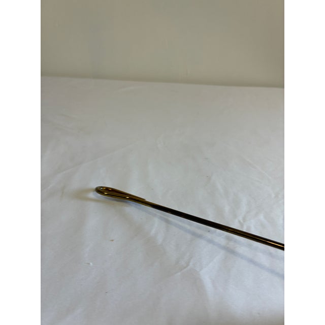 This classic brass candle snuffer features a bell-shaped cone with a scalloped edge and a long slender handle for reaching...