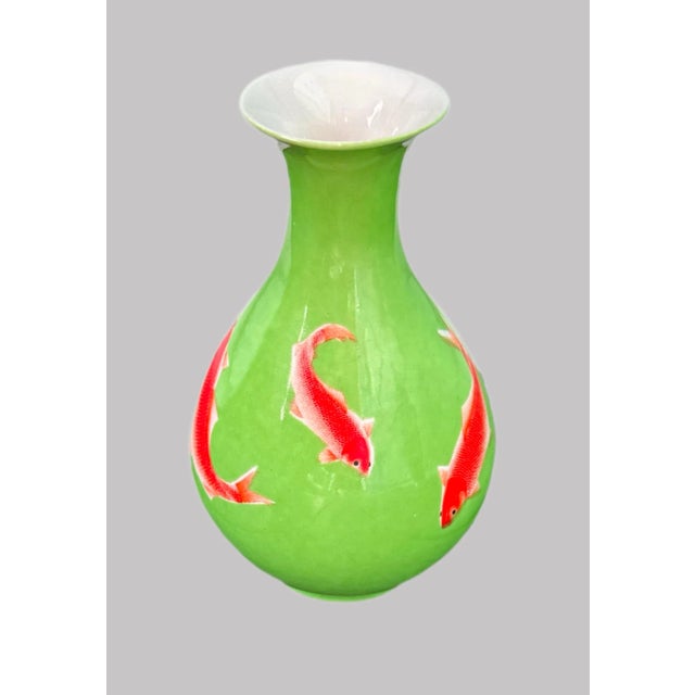 Vintage Chinese Porcelain Koi Fish Vase. Orange and black koi fish adorn this vibrant green Chinese bud vase. White petite...