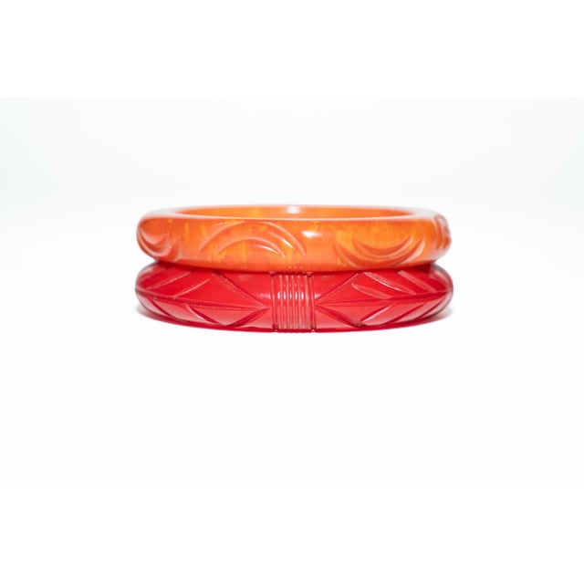 This pair of vintage 1930's carved bakelite bangle bracelets are a great color combination of red and burnt orange....