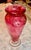 A striking hand‑blown art glass vase showcasing a vivid marbled palette of pink, fuchsia, orange, and soft gold. The...