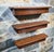 Set of three Mid-Century oak floating wall shelves retaining their original finish with a warm, naturally developed...