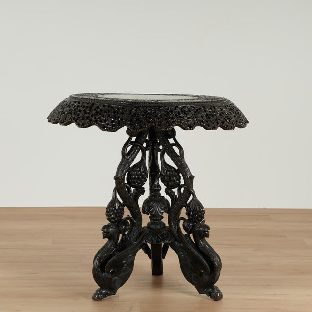 Standout 19th century Anglo Indian tilt top table handcrafted in rosewood with dramatic wood grains featuring a round top...