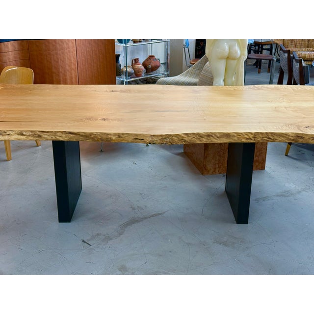 A stunning live edge dining table hand crafted out of English Elm and detailed with butterfly joining. The table rests of...