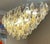 This chandelier consists dozens of hand blown gray, amber and clear "Poliedri" made of Murano glass with a brass frame....