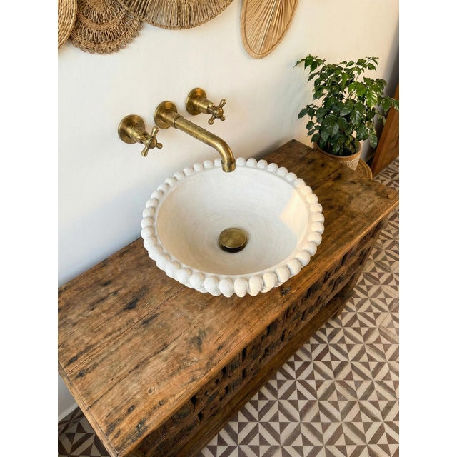 This handcrafted white marble bubble rim vessel sink is designed with a mix of vintage style and modern elegance. Made...