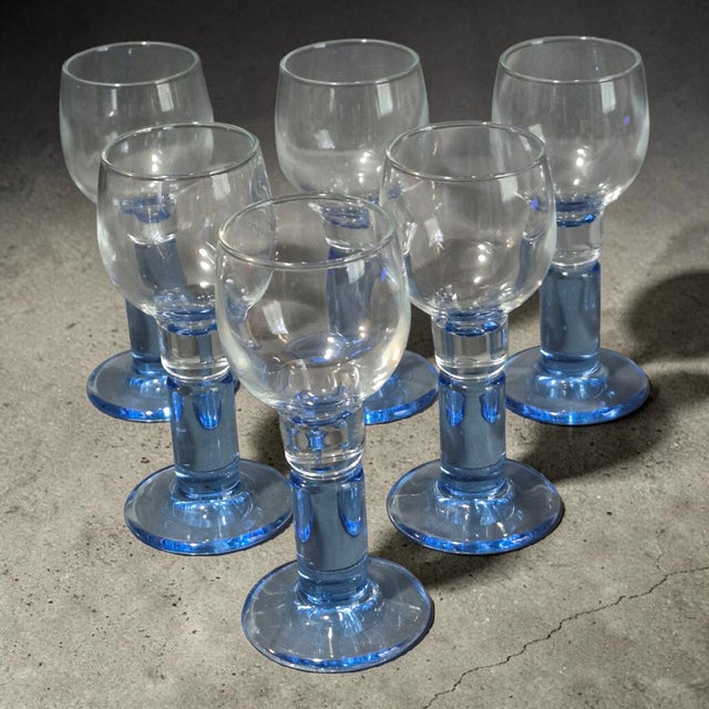 This vintage set of 6 Angela cordial glasses features stunning blue stems and a mid-century modern style, adding a touch...