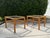 Vintage pair of woven rattan end tables with rectangular glass tops. The tables feature substantial hand-woven rattan...