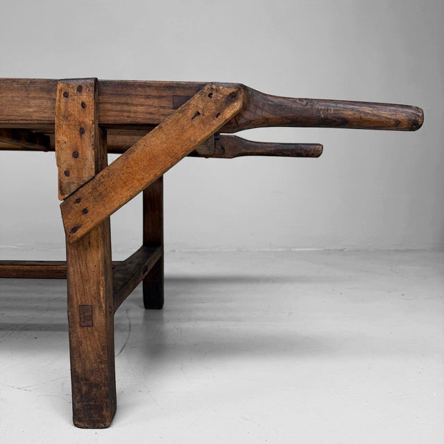An exceptional antique wooden carrying stretcher with an open slatted surface, long handles, and a powerful sculptural...