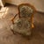 A Louis XV style armchair with a carved wooden frame, shaped armrests, cabriole legs, and floral tapestry upholstery....