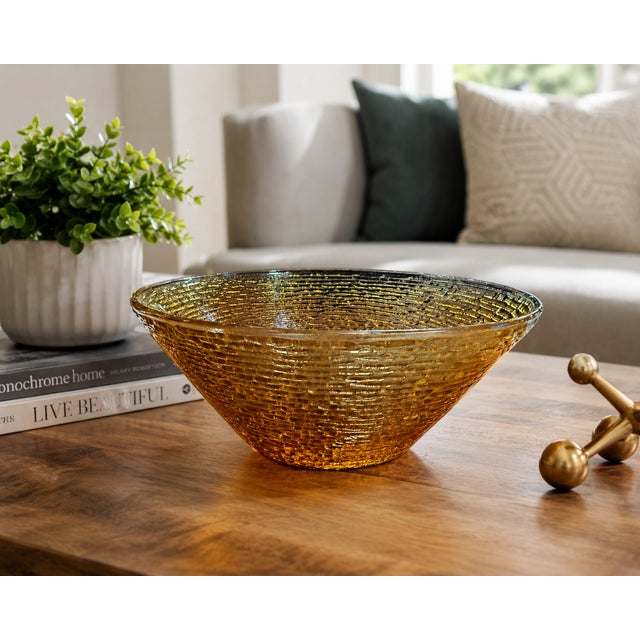 This vintage amber art glass bowl showcases a richly textured bark-like surface that beautifully refracts light from every...