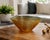 This vintage amber art glass bowl showcases a richly textured bark-like surface that beautifully refracts light from every...