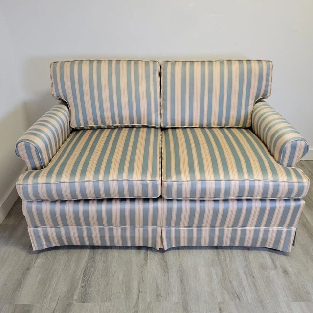 This petite loveseat, crafted by Walker Furniture Company of High Point, North Carolina, showcases the exceptional...