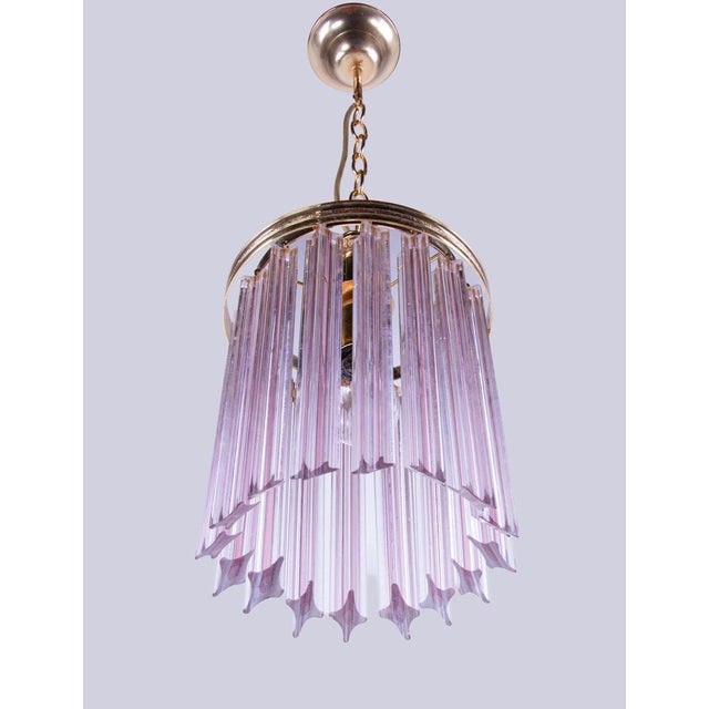 Elegant petite chandelier made of 16 pink “quadriedri” crystal glass prisms hanging on a brass frame. A piece of jewelry...
