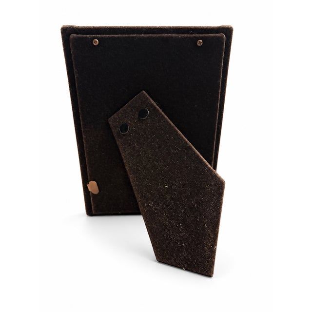 Elegant two-tone picture frame from the Anniversaire collection by Loui Michel Co. A polished silver-tone surround is...