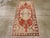A vintage Turkish Oushak throw rug. Vigorous sawtooth leaves project from the medallion and corners into the red field of...