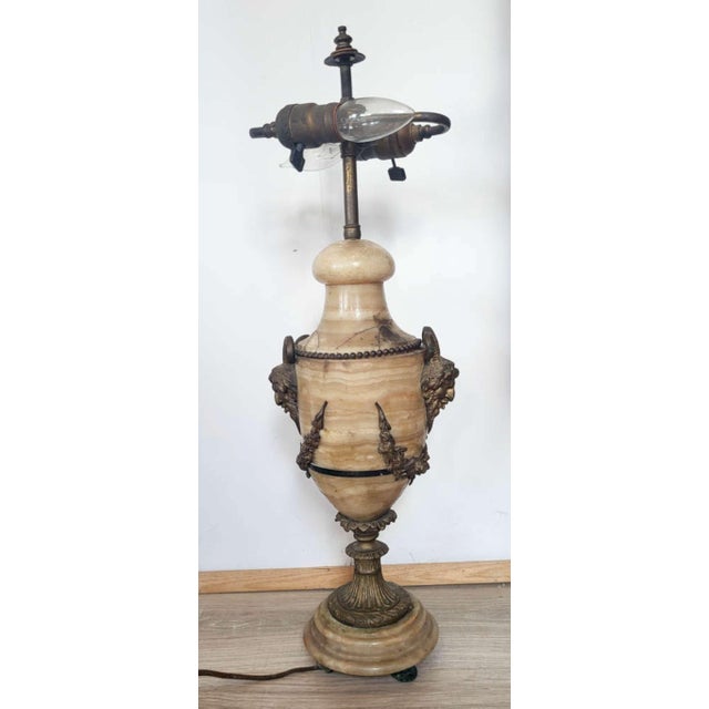 I’m selling an antique beige Onyx, or veined marble table lamp base, with bronze applied wreath accents and also bronze...