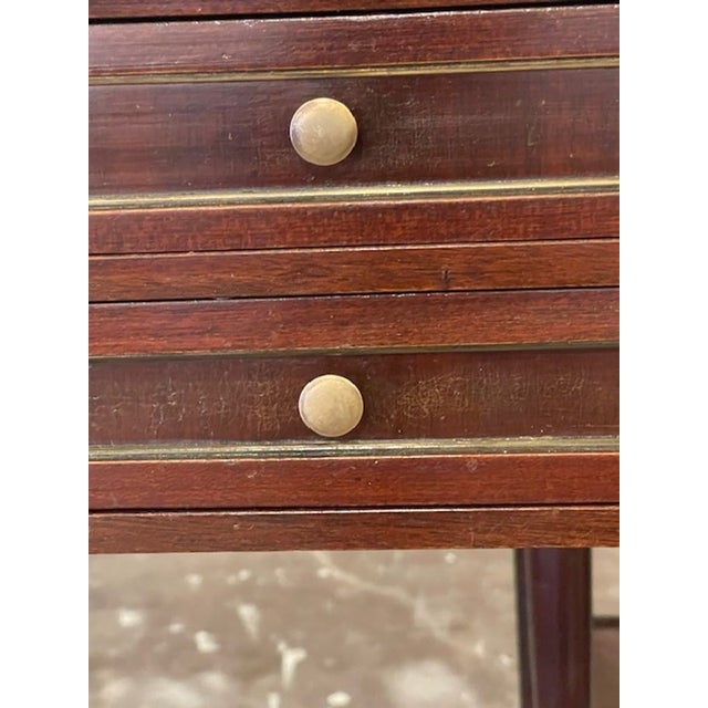 This pair of French Jansen Manner side tables are exquisitely crafted from mahogany with brass accents, adding a touch of...