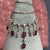 A cascade of fire and ice, this striking Belle Époque era necklace shimmers with old-world glamour. Scarlet garnets, deep...