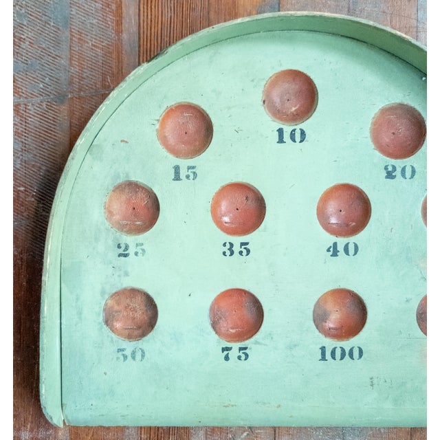 We are selling this cool primitive folk art Skee Ball game. This wood piece is painted in pistachio green color with red...