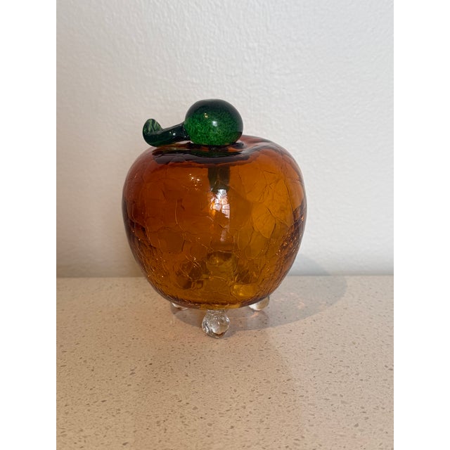 Vintage hand-blown art glass fruit fly trap in the form of an apple, crafted in warm amber-orange crackle glass with a...